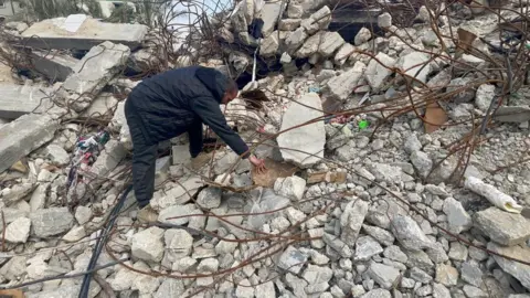 Residents continue to search the rubble