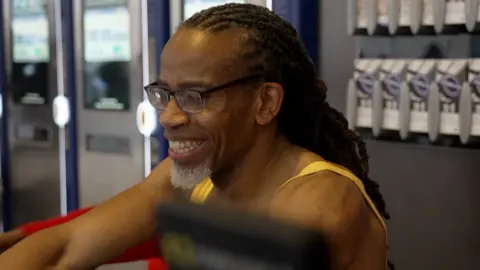 Luxmy Gopal/BBC Weininger Irwin on a rowing machine.