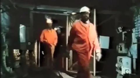 Skin and Coal/Claudine Booth Black miners leave the mine - from Skin and Coal by Claudine Booth (1987)