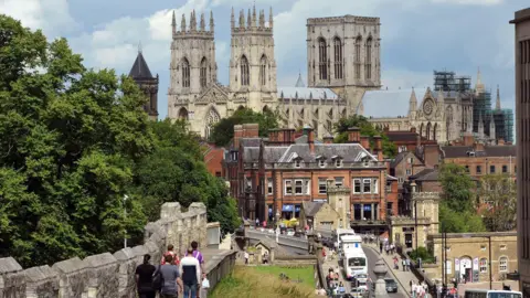 Jeff Overs/BBC a view of York taken from the Bar Walls looking down Lendal Bridge towards York Minster