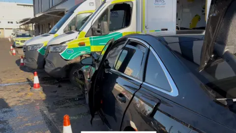 The two ambulances pictured with the car smashed in its side