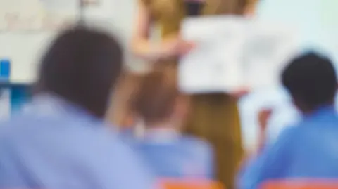 Blurred stock image of pupils in a class