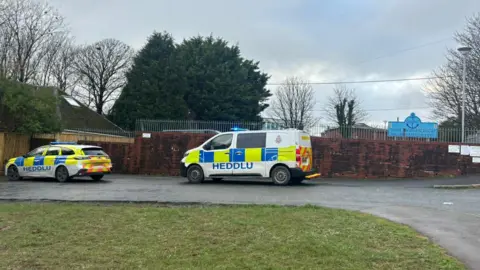 Pembrokeshire Herald A police car and van are seen outside a school