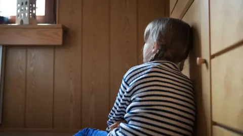 Getty Stock picture of a girl staring at a window