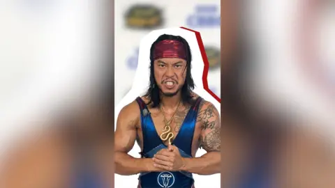 A man in a blue unitard and red bandana clenches his fists.