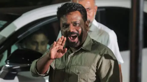 Reuters Anura Kumara Dissanayake, presidential candidate and leader of the opposition party National People's Power (NPP), shows his ink-marked finger after casting his vote during the presidential election, in Colombo, Sri Lanka, 21 September 2024.