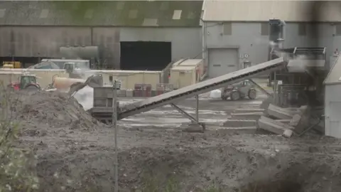 A general view of Saxon Pit, an industrial site with tractors and other vehicles.