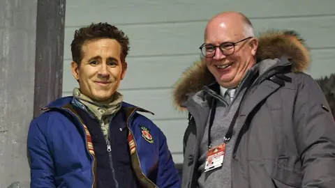 Shaun Harvey and Ryan Reynolds watch a game at the Stok Cae Ras. 