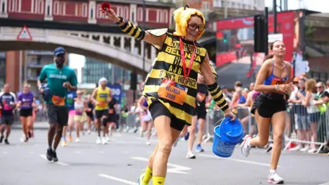 A woman dressed as a bee participates in the 2025 run