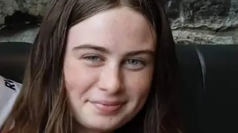 Family handout Shows a young girl with long brown hair smiling