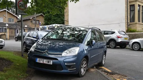 LDRS/Bradford Council A car parked diagonally on a path.