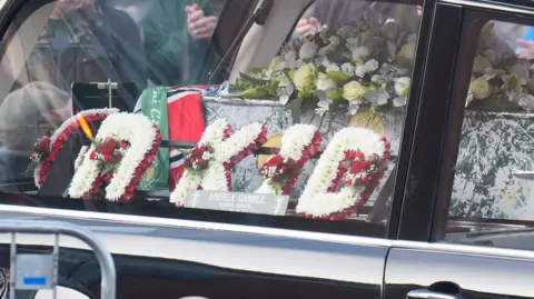 PA A wreath of flowers reading "R Kid" inside the hearse