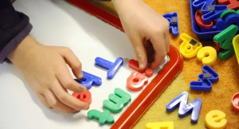 PA Media A charity has said a childcare shortage is hitting women who would like to work 
