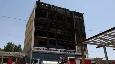 Five floors of the Corniche Hypermarket building are burned out in a photo taken the morning after the fire
