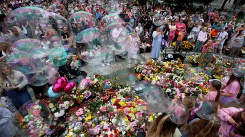 PA Media Hundreds attended a vigil for the victims of the Southport attack. There was hundreds of flowers, balloons and tributes left with huge bubbles blown at the event in the Town Hall Gardens outside The Atkinson in Southport.