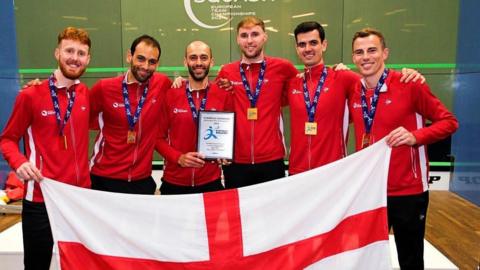 England men hold up an England flag after winning gold