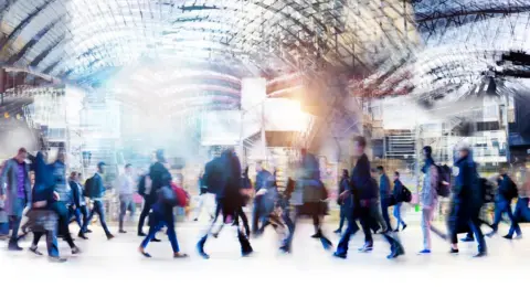 Getty Images Commuters walking quickly