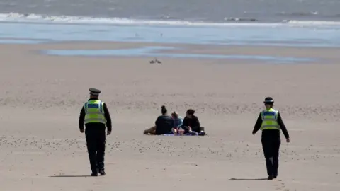 Getty Images Police on Barry Island beach