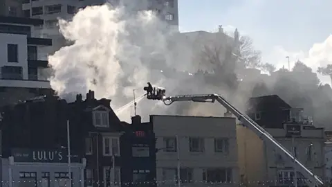 Chris Hart Fireman uses turntable ladder to reach the fire