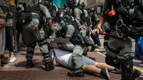 Getty Images A man is detained by riot police during a demonstration on July 1, 2020 in Hong Kong, China.