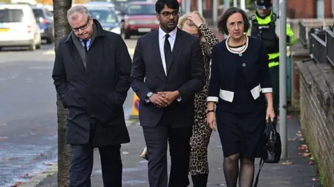 Pacemaker United States Consul General in Belfast Paul Narain and other mourners