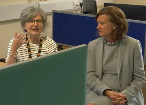 Welsh government Eluned Morgan meets a call handler at Hywel Dda health board's waiting list support service