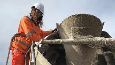 BBC Manager and ex-apprentice Emily Burridge inspects a batch of concrete