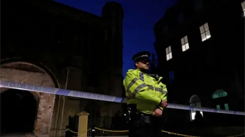 AFP Police officer stands guard at the gatehouse entrance to the park