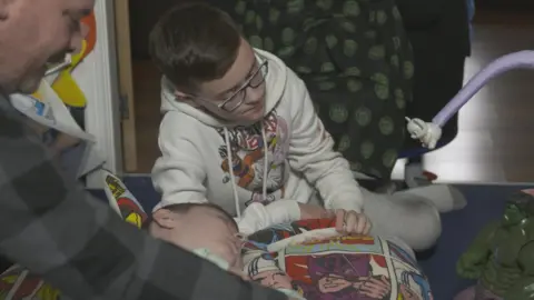 Macsen playing with dad Matthew and brother Ioan at home