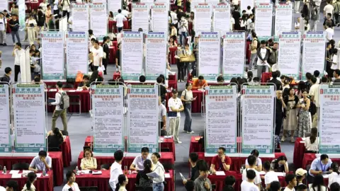 Reuters People attend a job fair for university graduates at a gymnasium in Hefei, Anhui province, China September 4, 2023.