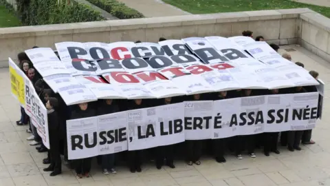 Protesters in Paris commemorate the murder of Russian journalist Anna Politovskaya, who was critical of the war in Chechnya