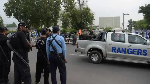 Getty Images Pakistani paramilitary soldiers and policemen cordon off the main entrance of the Supreme Court building during a hearing on the Panama Papers case in Islamabad on July 28, 2017.