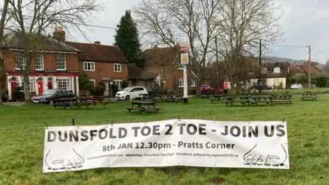 Paul Savident General view of Pratts Corner with a banner