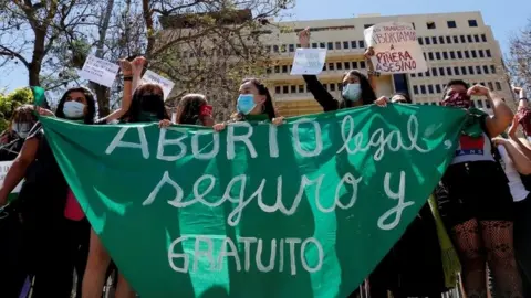 Reuters Pro-choice activists shout slogans outside Congress where lawmakers will begin to discuss a bill that decriminalises abortion until the 14th week of gestation, in Valparaiso, Chile January 13, 2021.