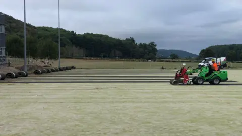 BBC The school's pitch being ripped up
