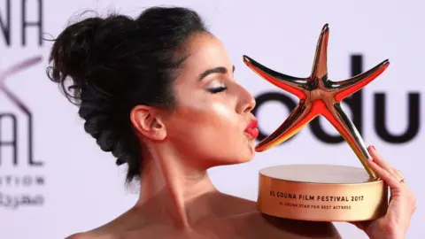 AFP Moroccan actress Nadia Kounda kisses her award for her award for best actress, El-Gouna, Egypt - Friday 29 September 2017