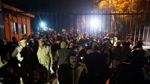 AFP Police gather outside a gate of the Jawaharlal Nehru University (JNU) in Delhi on January 5, 2020