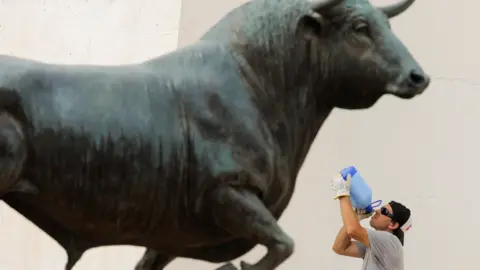 Reuters A man cools down with a drink of water at Ronda's Monumento al Toro