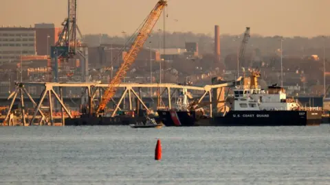 Getty Images A crane works on the debris of the Francis Scott Key Bridge on March 29, 2024 in Baltimore, Maryland.