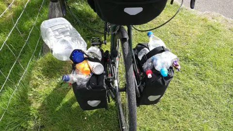 Ewen Weatherspoon Bike panniers filled with litter