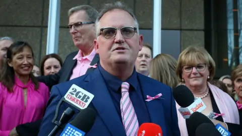 Getty Images Hedley Thomas speaks to media outside court