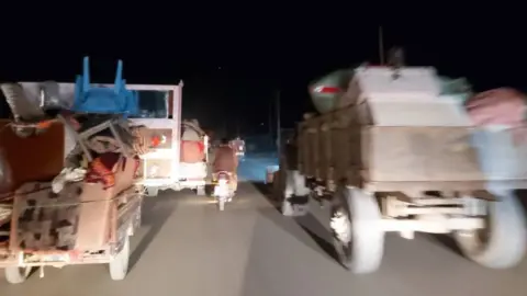 Gul Mohammad Vehicles stacked with possessions