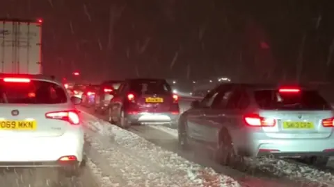 Vehicles in snow on M6