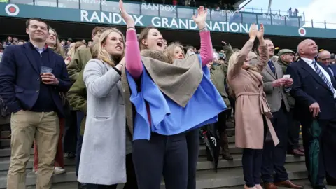 PA Media Racegoers celebrate at Aintree