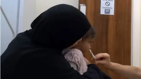 ABMU Health Board Kalsoom Khairuddin getting the flu spray