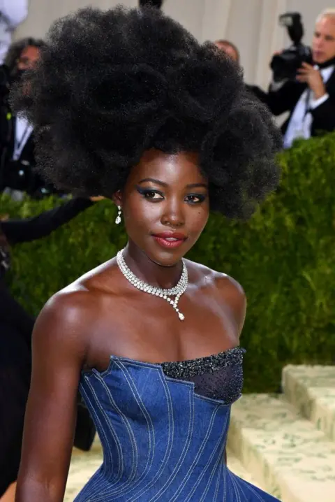 AFP Lupita Nyong'o poses on the red carpet.