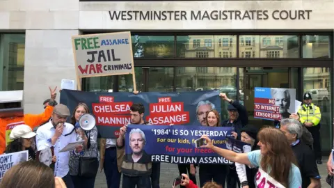 PA Julian Assange supporters outside Westminster Magistrates Court where the WikiLeaks founder is expected to appear via videolink as he continues to fight against extradition to the United States over allegations he conspired to break into a classified Pentagon computer.