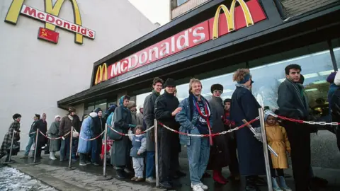 Getty Images People queue to enter a newly opened McDonald's on Gorky Street in Moscow in 1990