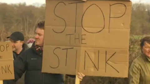 Protesters holding placards