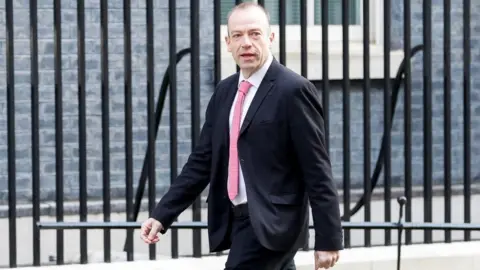 Reuters Chris Heaton-Harris walking outside Downing Street in Mar 2022